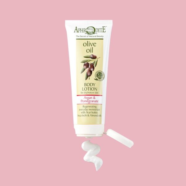 Aphrodite Body Lotion with Argan & Pomegranate in a field of pomegranate seeds